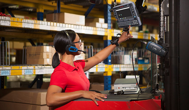 A warehouse worker interacting with a mobile computer.